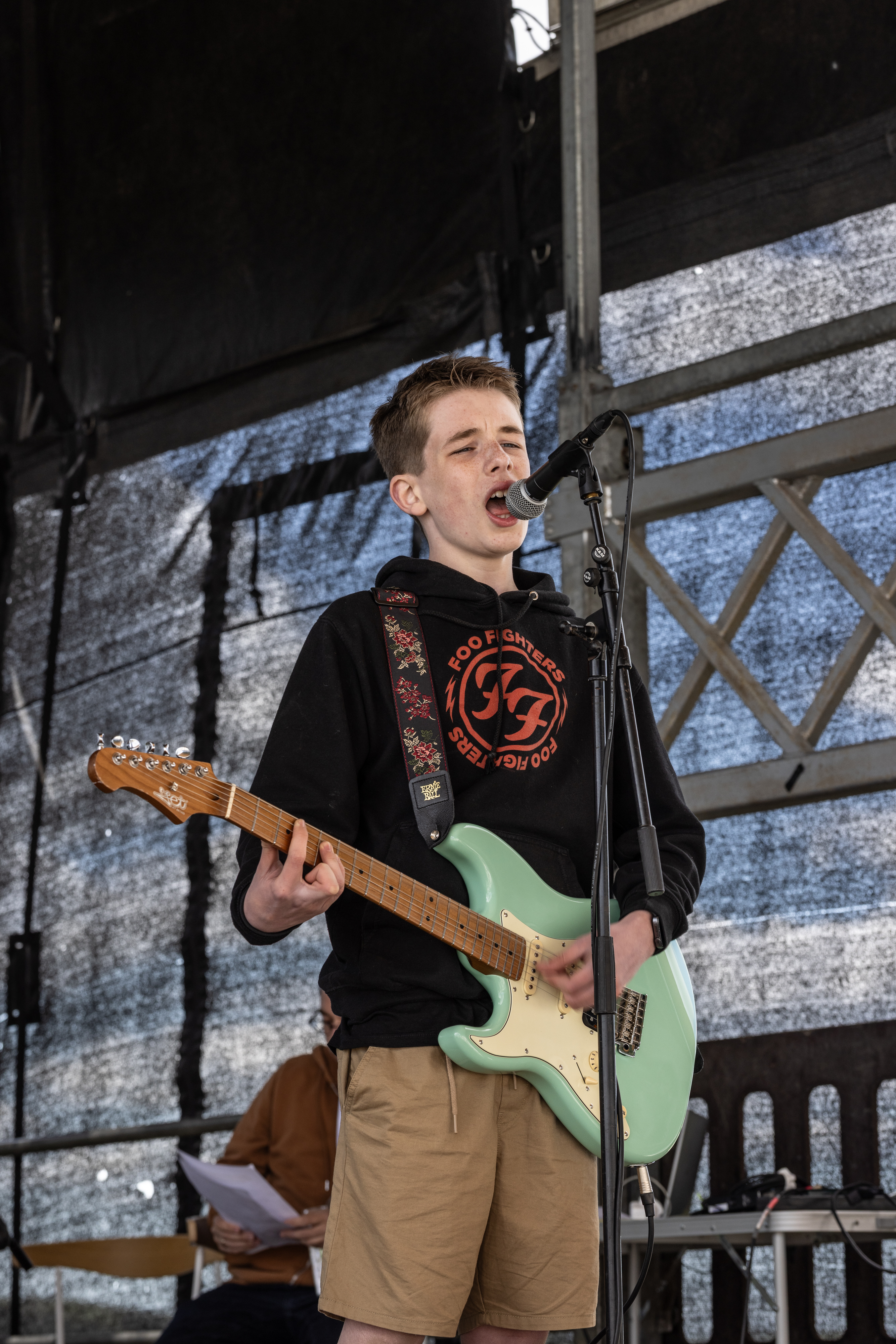 Person singing and playing guitar. 